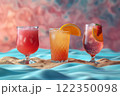 Still life of three bright yellow and red drinks in different glasses against the backdrop of a blue pool and golden sand in a neon style. 122350098