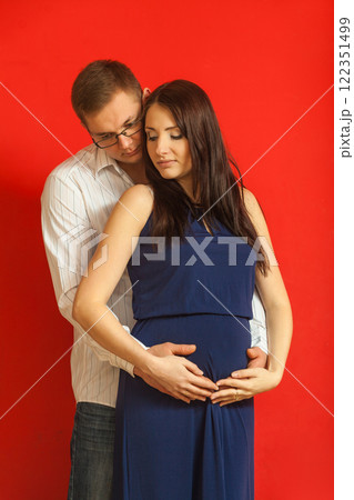 Pregnant woman with big belly and man posing. Pregnant woman with big belly and man posing. 122351499
