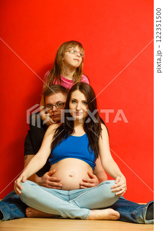 Pregnant woman, man and daughter posing. Pregnant woman, man and daughter posing. 122351500