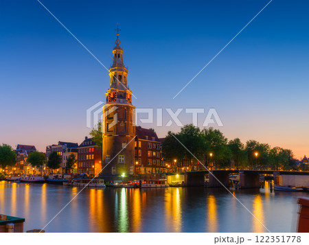 Montelbaan tower, Amsterdam, Netherlands. Evening cityscape. Dark sky and city lights. Montelbaan tower, Amsterdam, Netherlands. Evening cityscape. Dark sky and city lights. 122351778