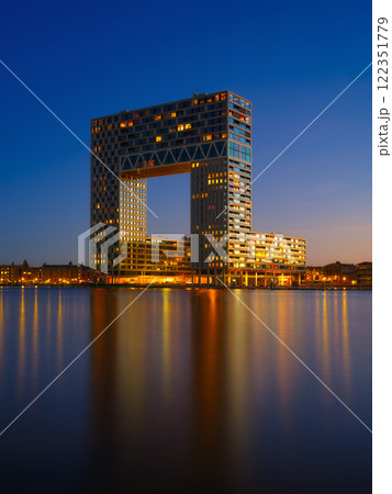 Amsterdam, Netherlands. A cityscape during sunset. Dark sky and city lights. Dutch canals. Amsterdam, Netherlands. A cityscape during sunset. Dark sky and city lights. Dutch canals. 122351779