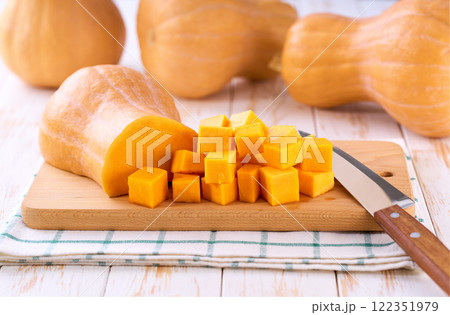 Diced butternut squash on wooden cutting board, selective focus. Diced butternut squash on wooden cutting board, selective focus. 122351979