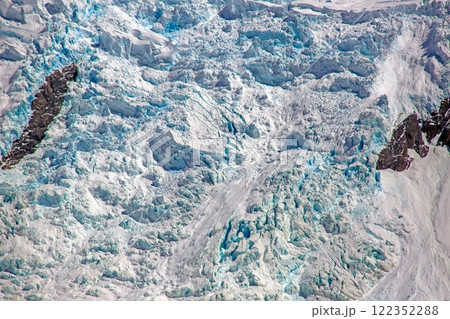 Glacier detail with crevasses and shimmering blue ice 122352288