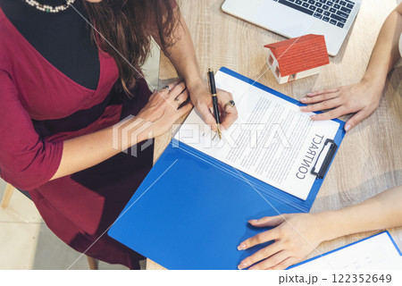 Close up Team Businesswoman hands partners sign contract with success business deal. Diversity Businesswoman teams handshake together. Partnership teamwork meeting signing contract business concept 122352649
