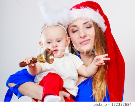 Mother wearing santa hat holding baby 122352684