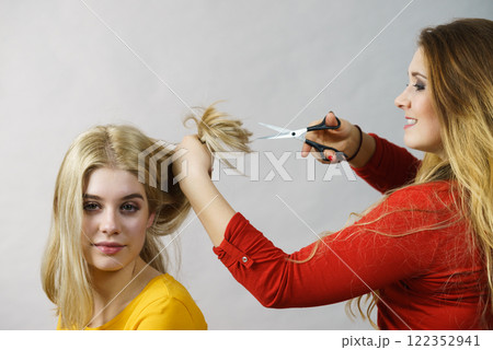 Woman with scissors ready to hair cutting Woman with scissors ready to hair cutting 122352941