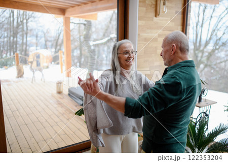 Older couple in love, having fun and dancing in living room. Older couple in love, having fun and dancing in living room. 122353204