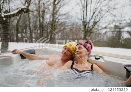 Senior couple couple using a hot tub. Concept of Valentine's weekend getaway. 122353220