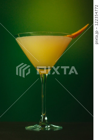 Refreshing Citrus Martini with Orange Garnish and Mint Vibrant Cocktail Against Lush Green Backdrop Refreshing Citrus Martini with Orange Garnish and Mint Vibrant Cocktail Against Lush Green Backdrop 122354772