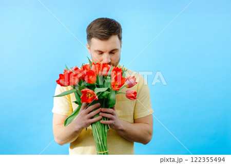 Man holding bouquet of red tulips 122355494