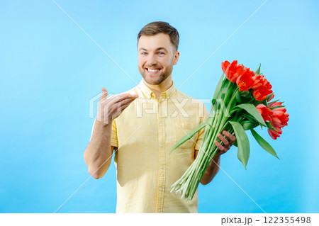 Man holding bouquet of red tulips Man holding bouquet of red tulips 122355498