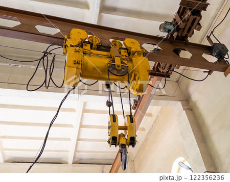 Industrial overhead crane system with a hoist and hook for lifting heavy loads. 122356236