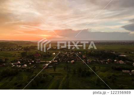Aerial view of residential houses in suburban rural area at sunset Aerial view of residential houses in suburban rural area at sunset 122356989