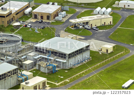 Aerial view of modern water cleaning facility at urban wastewater treatment plant. Purification process of removing undesirable chemicals, suspended solids and gases from contaminated liquid Aerial view of modern water cleaning facility at urban wastewater treatment plant. Purification process of removing undesirable chemicals, suspended solids and gases from contaminated liquid 122357023