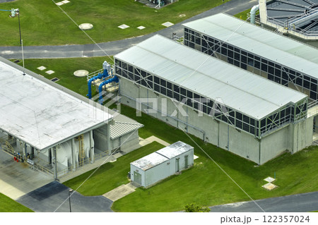 Aerial view of modern water cleaning facility at urban wastewater treatment plant. Purification process of removing undesirable chemicals, suspended solids and gases from contaminated liquid Aerial view of modern water cleaning facility at urban wastewater treatment plant. Purification process of removing undesirable chemicals, suspended solids and gases from contaminated liquid 122357024