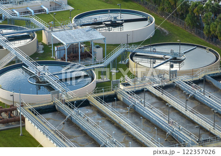 Aerial view of modern water cleaning facility at urban wastewater treatment plant. Purification process of removing undesirable chemicals, suspended solids and gases from contaminated liquid 122357026
