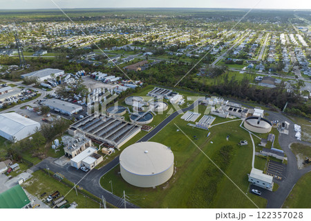 Aerial view of modern water cleaning facility at urban wastewater treatment plant. Purification process of removing undesirable chemicals, suspended solids and gases from contaminated liquid Aerial view of modern water cleaning facility at urban wastewater treatment plant. Purification process of removing undesirable chemicals, suspended solids and gases from contaminated liquid 122357028