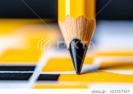 A close up of a yellow pencil on a chess board 122357337
