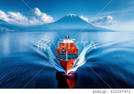 A large container ship in the ocean with a mountain in the background 122357472