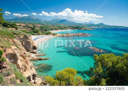 A view of a beach with a sandy shoreline and clear blue water 122357605
