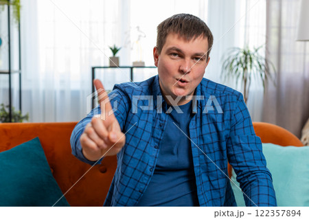 Displeased upset man reacting to unpleasant awful idea dissatisfied with bad quality shake finger No 122357894