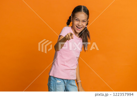 Happy excited child girl laughing out loud after hearing ridiculous anecdote, reaction on funny joke 122357994