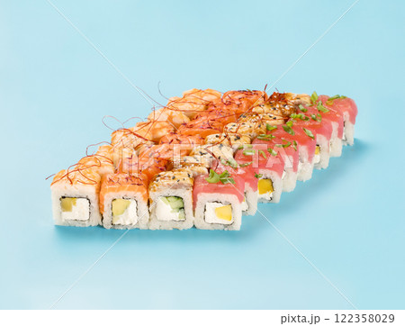 Philadelphia Roll Set with mango, cucumber and avocado, wrapped in perfect seasoned sushi rice and fresh salmon, tuna, shrimp and smoked eel, decorated chili threads. Isolated on light blue background Philadelphia Roll Set with mango, cucumber and avocado, wrapped in perfect seasoned sushi rice and fresh salmon, tuna, shrimp and smoked eel, decorated chili threads. Isolated on light blue background 122358029