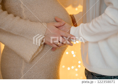 Expectant couple gently cradling baby bump in intimate moment of love and anticipation Expectant couple gently cradling baby bump in intimate moment of love and anticipation 122358071