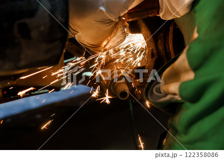 Sparks Fly as a Mechanic Performs Precision Metal Work Sparks Fly as a Mechanic Performs Precision Metal Work 122358086