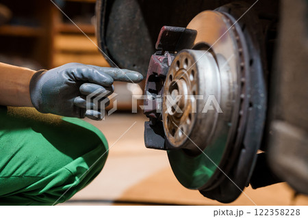 Detailed Inspection of a Car Brake System in an Auto Repair Shop 122358228