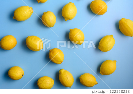 Top view of yellow lemons on blue background. 122358238