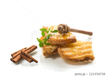 bread fried sweet toasts with honey on wooden board with cinnamon bread fried sweet toasts with honey on wooden board with cinnamon 122358736