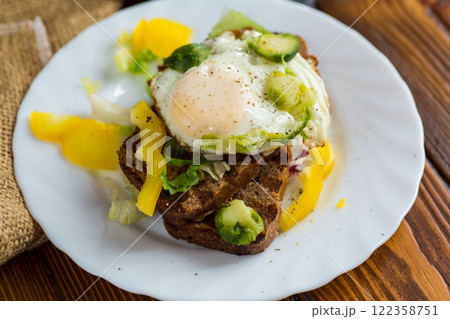 Egg on bread with vegetable garnish Egg on bread with vegetable garnish 122358751