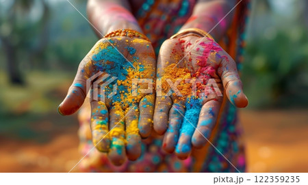 Happy Holi , Concept Indian color festival. close-up female hands with colored powder over dark 122359235