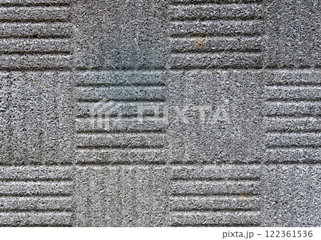 Close-up of patterned concrete texture with grooves and rough surface. 122361536
