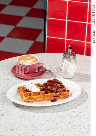 Portion of waffle with brisket and coffee Portion of waffle with brisket and coffee 122361618