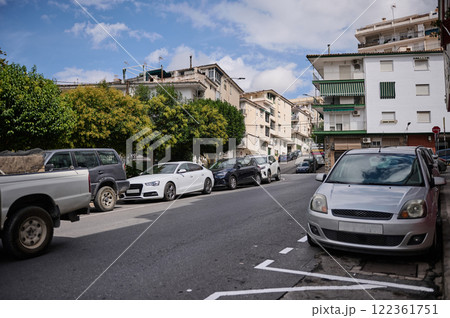 Urban street view with parked cars in a residential neighborhood 122361751