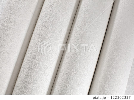 White tubes of paper wallpaper for repairs rolled into rolls. 122362337