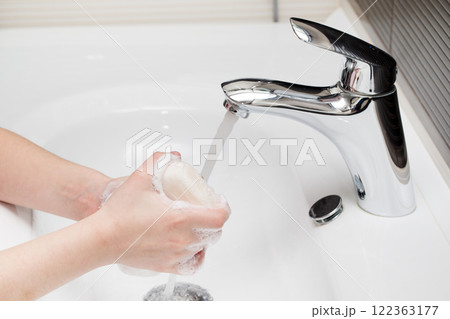 washing hands with soap. Little girl is washing her hands to prevent virus and germs. washing hands with soap. Little girl is washing her hands to prevent virus and germs. 122363177