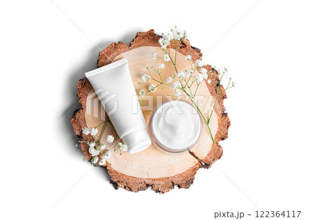 Cosmetic products and gypsophila flowers on wood cut Cosmetic products and gypsophila flowers on wood cut 122364117