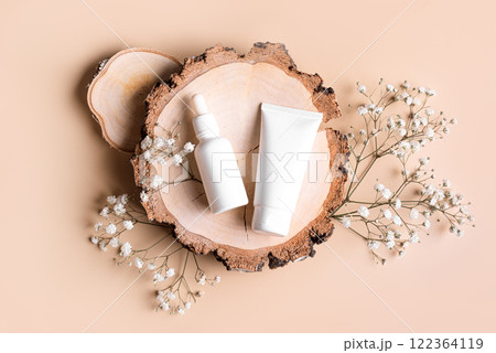 Cosmetic products and gypsophila flowers on wood cut 122364119