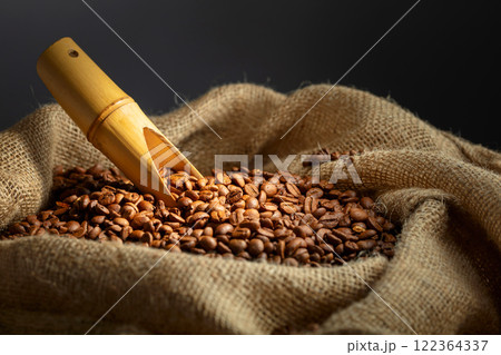 Roasted coffee beans in burlap bag. 122364337