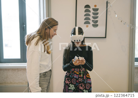 Children Engaging in an Exciting Exploration of Virtual Reality within a Creative Environment Children Engaging in an Exciting Exploration of Virtual Reality within a Creative Environment 122364715