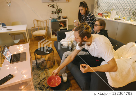 Enjoy a Cozy Movie Night with Friends while relaxing in a Modern and Comfortable Living Room 122364792