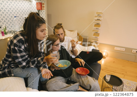 Enjoy a Cozy Movie Night with Friends in a Modern Living Room with Great Vibes and Comfort Enjoy a Cozy Movie Night with Friends in a Modern Living Room with Great Vibes and Comfort 122364875