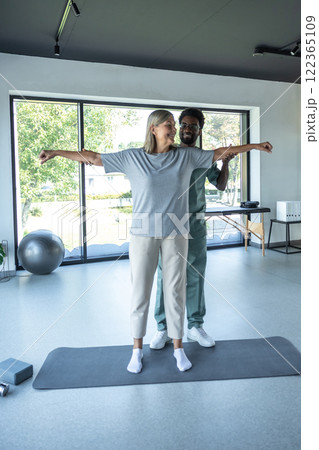 Woman patient in healthcare clinic having physio arms treatment of chiropractor Woman patient in healthcare clinic having physio arms treatment of chiropractor 122365109