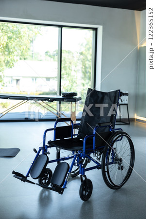 Empty rehabilitation room in hospital with wheelchair and therapy table Empty rehabilitation room in hospital with wheelchair and therapy table 122365152