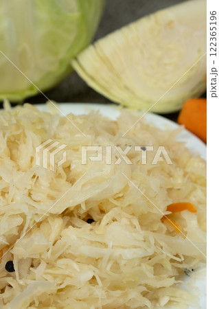 Sauerkraut salad traditional recipe consisting of cabbage, carrots, salt and peppercorns. Sauerkraut salad traditional recipe consisting of cabbage, carrots, salt and peppercorns. 122365196