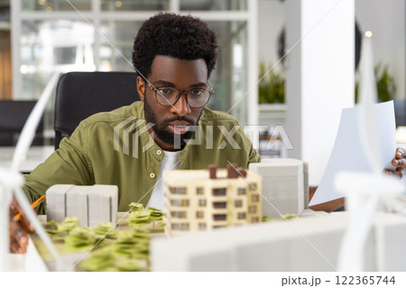 Young african american architect looking concentrated while working on a project 122365744
