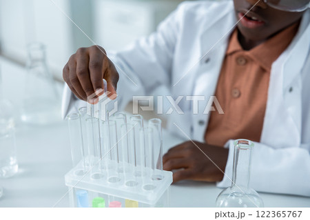 Female scientist holding tubes with liquid conducting experiment in chemistry Female scientist holding tubes with liquid conducting experiment in chemistry 122365767